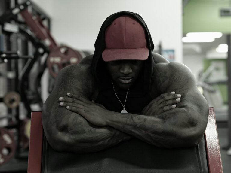 Muscular man resting on a gym bench
