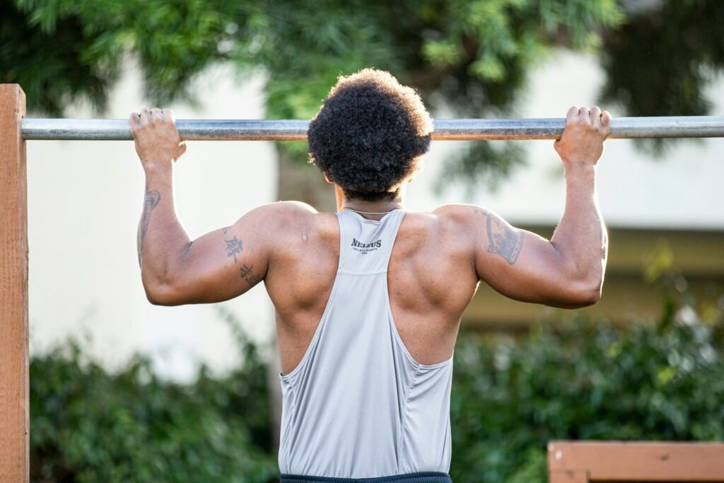 Man doing pull-ups outdoors
